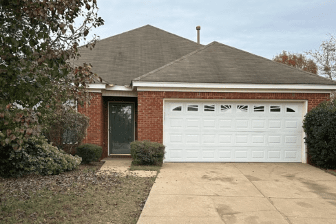 Brick house with white garage door.