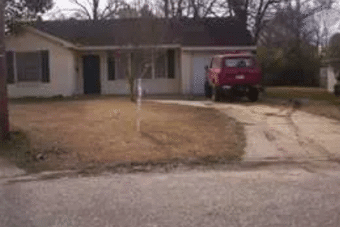 House with red truck in driveway.