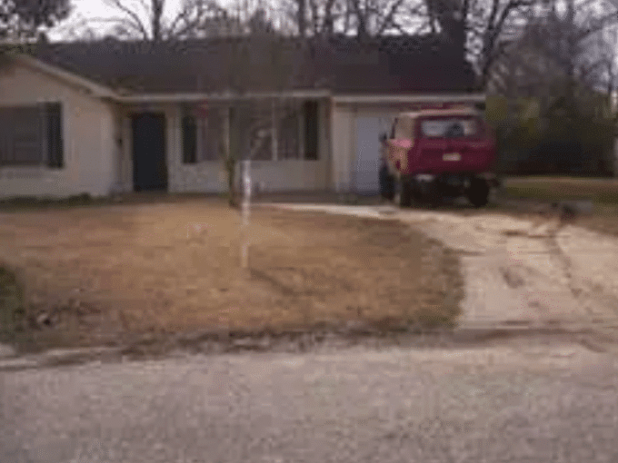 House with red truck in driveway.