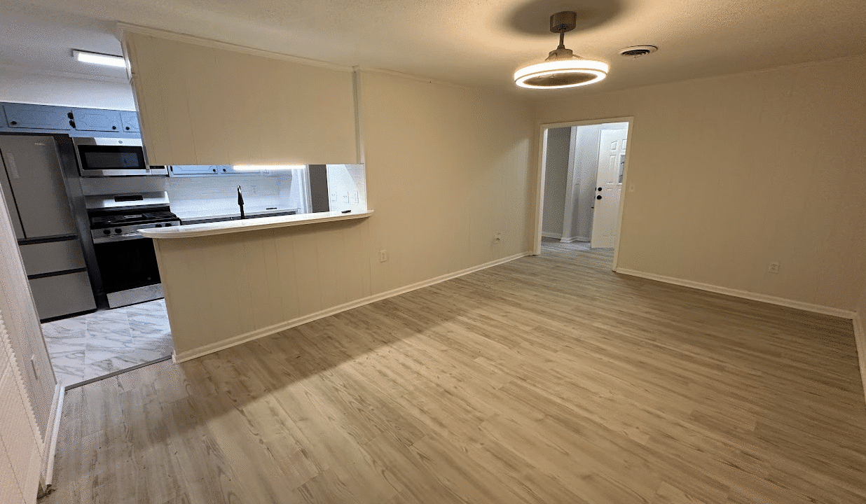 Open-plan living room with kitchen view.