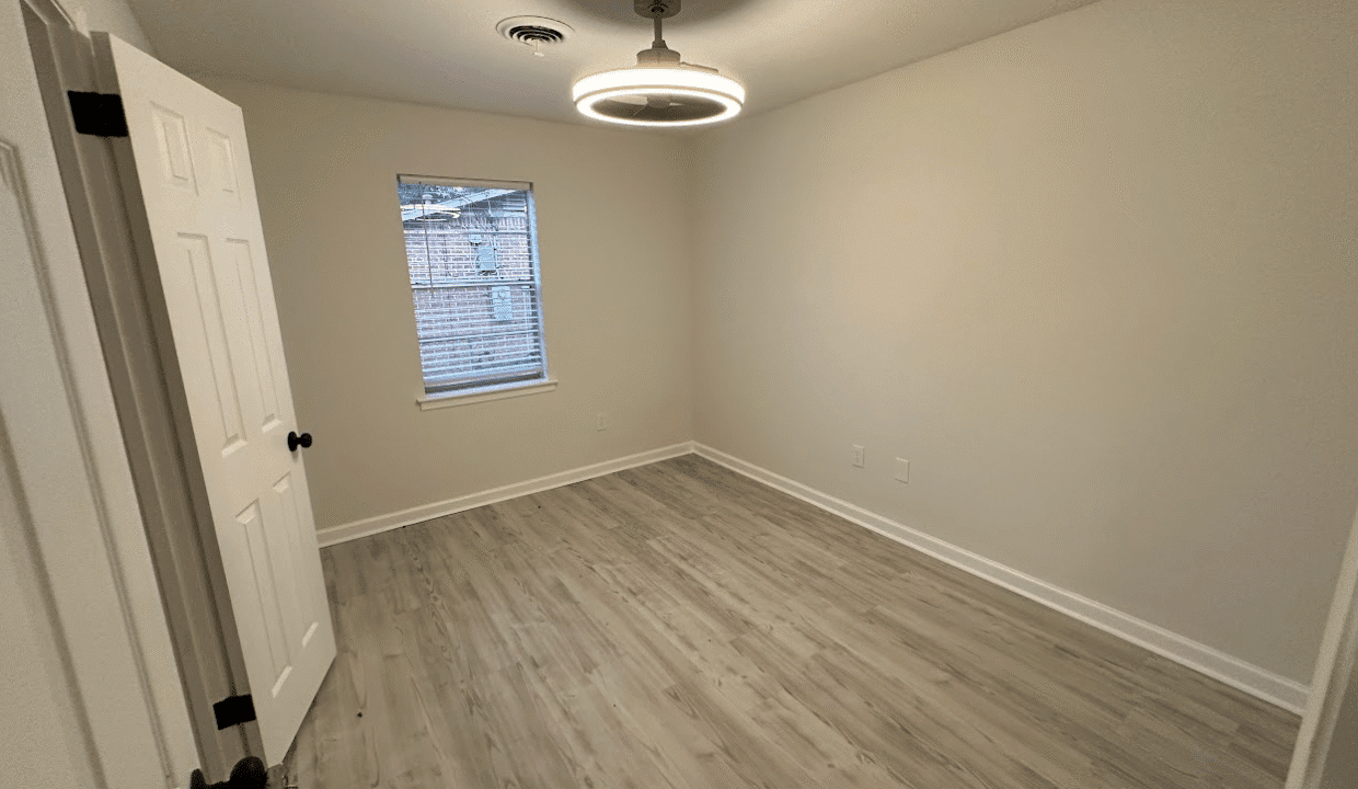 Empty room with wooden floor and window.