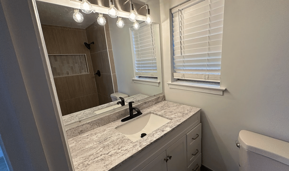 Modern bathroom with vanity and mirror.