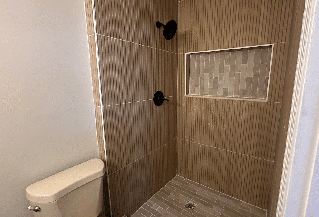Modern bathroom with shower and toilet.