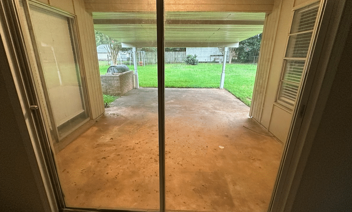 View of patio through sliding glass doors.