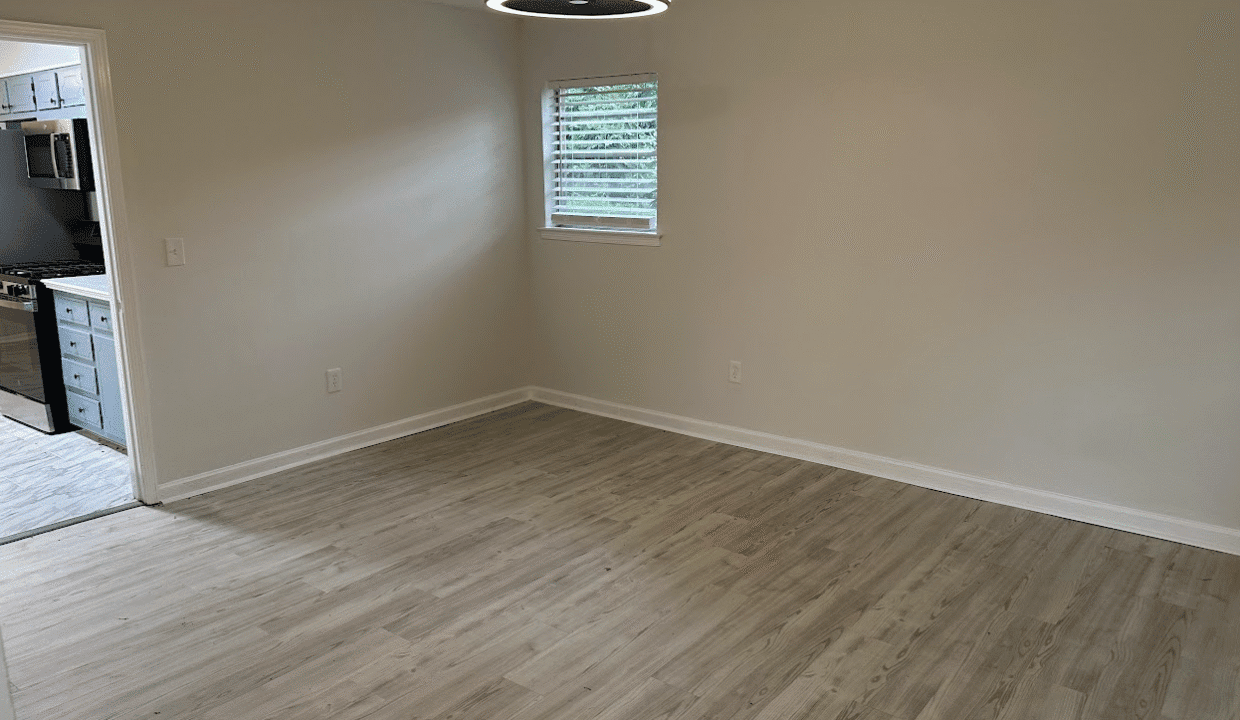 Empty room with wooden floor and window.