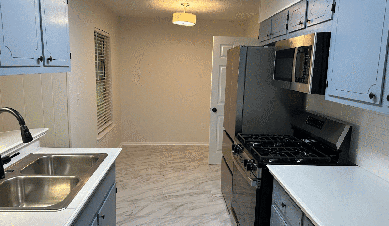 Modern kitchen with blue cabinets and appliances.