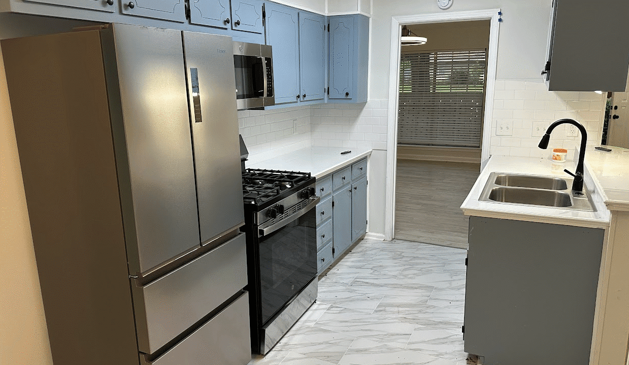Modern kitchen with stainless steel appliances.