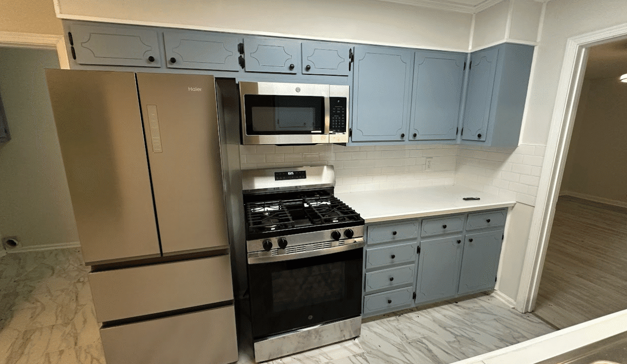 Modern kitchen with stainless steel appliances.