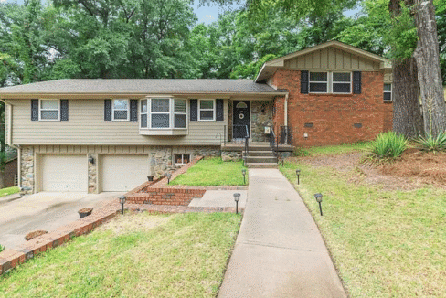 Suburban house with driveway and front yard.