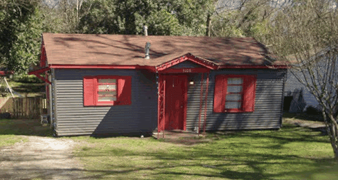 Gray house with red trim and door.