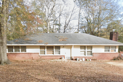 Single-story house surrounded by autumn trees.